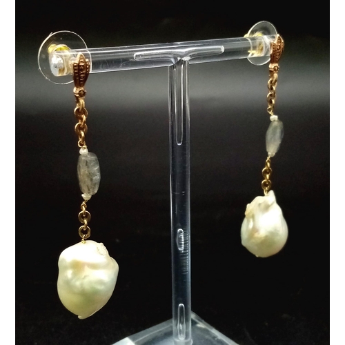 303 - A PAIR OF NATURAL PEARL DROP EARRINGS SET IN ROSE GOLD AND CRYSTAL WITH A 4cms DROP.    11,1gms