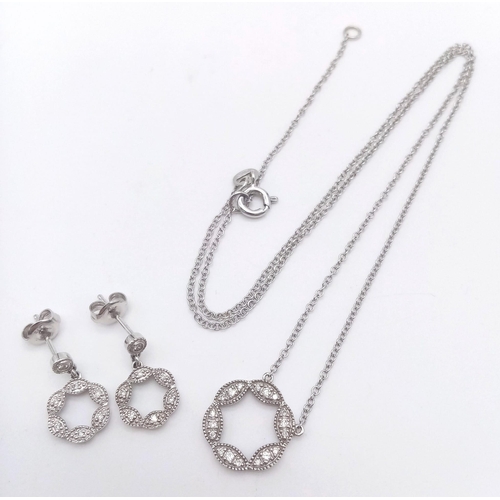 351 - A 9K WHITE GOLD AND DIAMOND PENDANT AND MATCHING EARRING SET .4.5gms