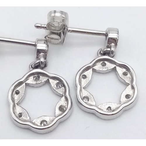 351 - A 9K WHITE GOLD AND DIAMOND PENDANT AND MATCHING EARRING SET .4.5gms