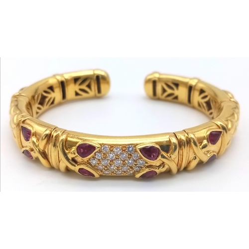 66 - AN 18K GOLD STUNNING INNER PIERCED BANGLE WITH BEAUTIFUL OUTER WORK AND DECORATED WITH  DIAMONDS AND... 