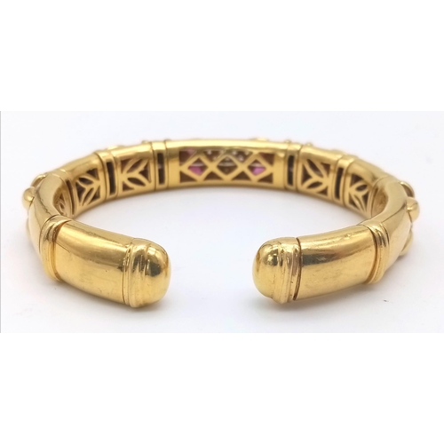 66 - AN 18K GOLD STUNNING INNER PIERCED BANGLE WITH BEAUTIFUL OUTER WORK AND DECORATED WITH  DIAMONDS AND... 