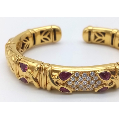 66 - AN 18K GOLD STUNNING INNER PIERCED BANGLE WITH BEAUTIFUL OUTER WORK AND DECORATED WITH  DIAMONDS AND... 