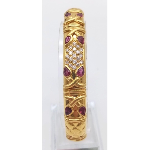 66 - AN 18K GOLD STUNNING INNER PIERCED BANGLE WITH BEAUTIFUL OUTER WORK AND DECORATED WITH  DIAMONDS AND... 