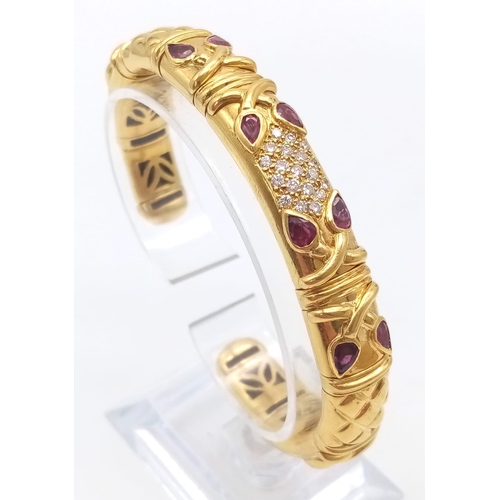 66 - AN 18K GOLD STUNNING INNER PIERCED BANGLE WITH BEAUTIFUL OUTER WORK AND DECORATED WITH  DIAMONDS AND... 