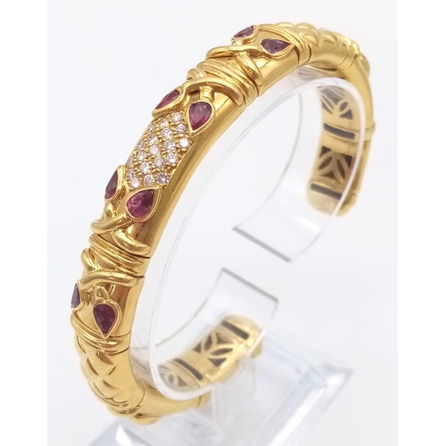 66 - AN 18K GOLD STUNNING INNER PIERCED BANGLE WITH BEAUTIFUL OUTER WORK AND DECORATED WITH  DIAMONDS AND... 