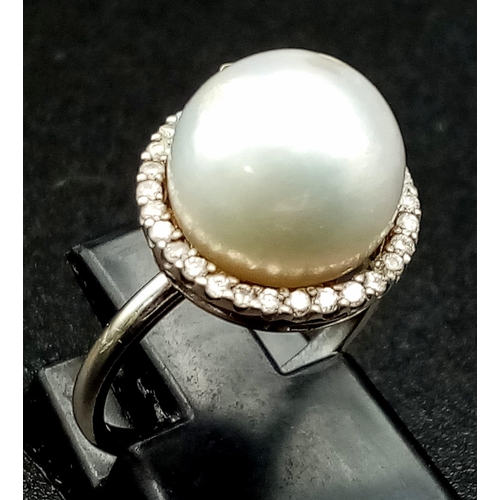 155 - A SOUTH SEA PEARL  RING SURROUNDED BY A HALO OF QUALITY DIAMONDS AND SET IN 18K WHITE GOLD .3.7gms  ... 