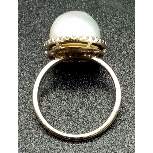 155 - A SOUTH SEA PEARL  RING SURROUNDED BY A HALO OF QUALITY DIAMONDS AND SET IN 18K WHITE GOLD .3.7gms  ... 