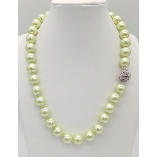 1627 - An Alluring Light-Green South Sea Pearl Shell Necklace. 12mm shell beads. Glitter-ball clasp. 42cm