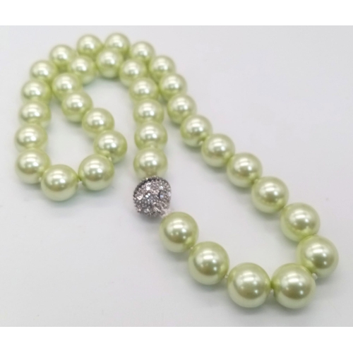 1627 - An Alluring Light-Green South Sea Pearl Shell Necklace. 12mm shell beads. Glitter-ball clasp. 42cm