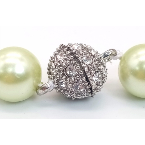 1627 - An Alluring Light-Green South Sea Pearl Shell Necklace. 12mm shell beads. Glitter-ball clasp. 42cm