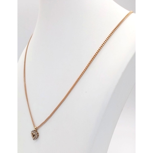 22 - A 52cms 9K GOLD CHAIN WITH A 9K GOLD AND DIAMOND HEART PENDANT .  7.9gms