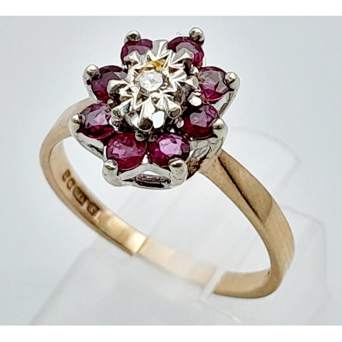 448 - 9K YELLOW GOLD DIAMOND & RUBY CLUSTER RING. TOTAL WEIGHT 3.1G.  SIZE P