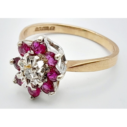 448 - 9K YELLOW GOLD DIAMOND & RUBY CLUSTER RING. TOTAL WEIGHT 3.1G.  SIZE P