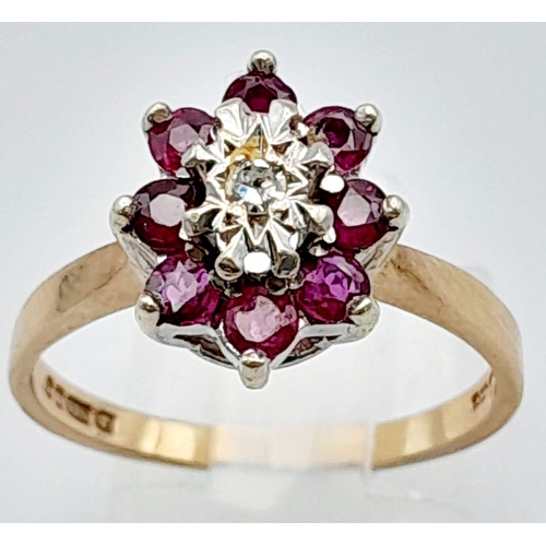 448 - 9K YELLOW GOLD DIAMOND & RUBY CLUSTER RING. TOTAL WEIGHT 3.1G.  SIZE P