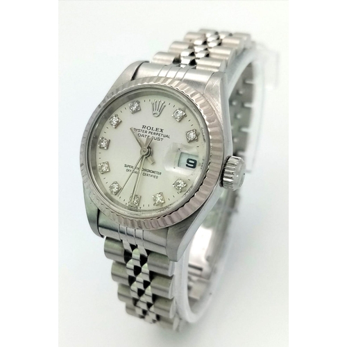 64 - A LADIES STAINLESS STEEL ROLEX OYSTER PERPETUAL DATEJUST WITH DIAMOND NUMERALS ON A WHITE FACE.  26m... 