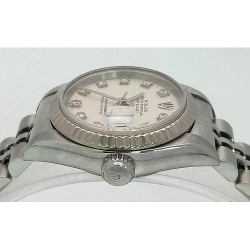 64 - A LADIES STAINLESS STEEL ROLEX OYSTER PERPETUAL DATEJUST WITH DIAMOND NUMERALS ON A WHITE FACE.  26m... 