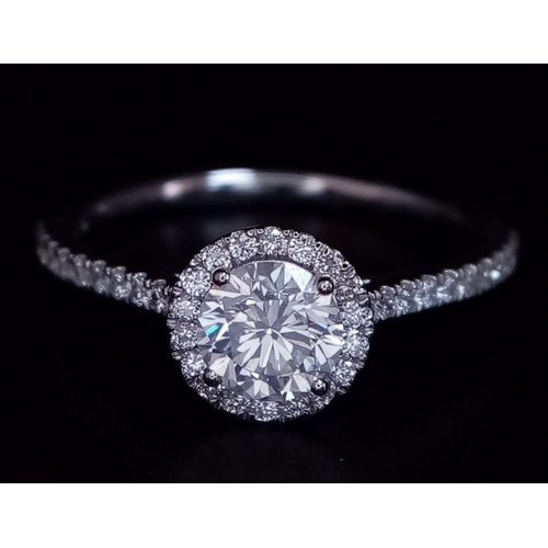 190 - A 950 Platinum Diamond Ring. 0.60ct central round brilliant diamond - D - colour, VVS1. A further 0.... 