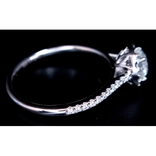 190 - A 950 Platinum Diamond Ring. 0.60ct central round brilliant diamond - D - colour, VVS1. A further 0.... 