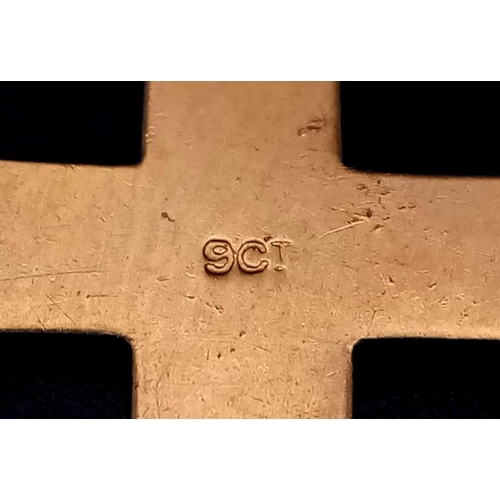 269 - A PLAIN AND TASTEFUL 9K GOLD CROSS . 1.3gms