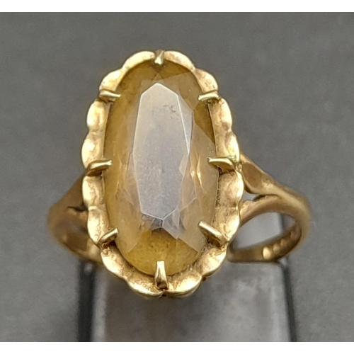 359 - A 9K GOLD DRESS RING WITH MOTTLED CITRINE STONE .  2.9gms   size K