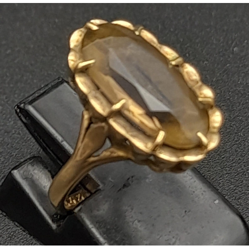 359 - A 9K GOLD DRESS RING WITH MOTTLED CITRINE STONE .  2.9gms   size K