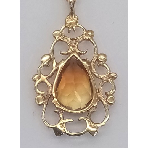 395 - A Citrine and 9K Yellow Gold Pendant on a 9K Yellow Gold Necklace. 2cm and 42cm.