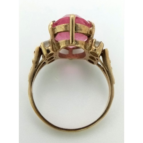 242 - A Vintage 9K Yellow Gold Ring with a Large Pink Central Gemstone. Size N 1/2. 3.95g total weight.