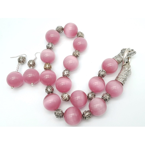 132 - A spectacular, large beaded (18 mm), pink cat’s eyes necklace with a Chinese silver snake clasp and ... 