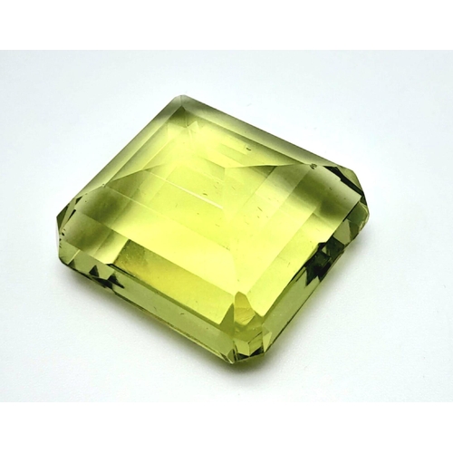 153 - A very desirable, large (76.8 carats) peridot. Emerald cut, with excellent colour uniformity and sat... 