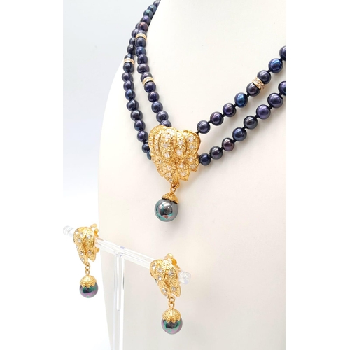 230 - A two row necklace with good quality black Tahitian pearls and 18 K yellow gold plated parts, accomp... 