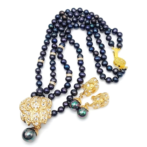 230 - A two row necklace with good quality black Tahitian pearls and 18 K yellow gold plated parts, accomp... 