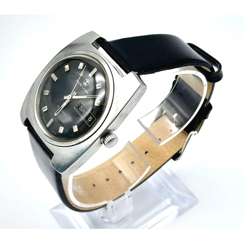 242 - A Vintage Favre-Leuba Duomatic Gents Watch. Black leather strap. Black dial with day/date window. In... 