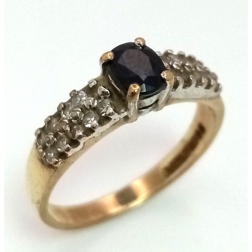 25 - A 9K Yellow Gold Sapphire and Diamond Ring. Central oval sapphire with diamond wings. Size J. 1.92g ... 