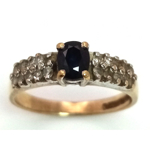 25 - A 9K Yellow Gold Sapphire and Diamond Ring. Central oval sapphire with diamond wings. Size J. 1.92g ... 