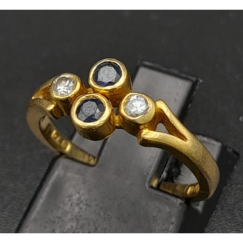 32 - A Vintage 18K Yellow Gold Diamond and Sapphire Ring. Two vertical sapphires and two horizontal diamo... 