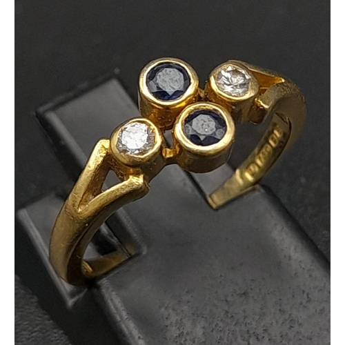 32 - A Vintage 18K Yellow Gold Diamond and Sapphire Ring. Two vertical sapphires and two horizontal diamo... 