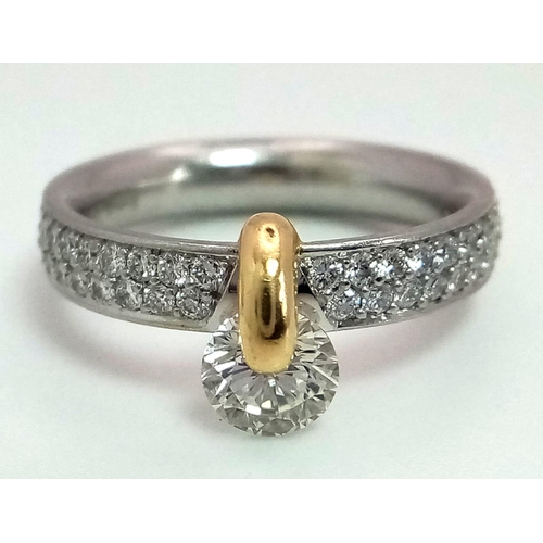 120 - A Gorgeous 950 Platinum and 18K Gold and Diamond Ring with Diamond Shoulders. 0.76ct brilliant centr... 