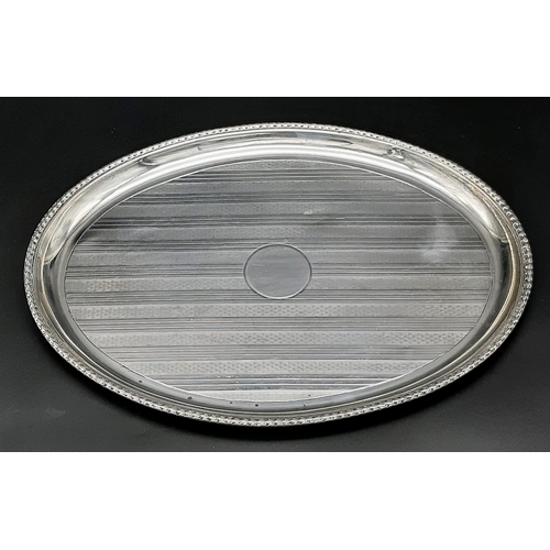 22 - A Small Antique 925 Silver Oval Tray. Machine tooled geometric decoration with empty cartouche. Hall... 