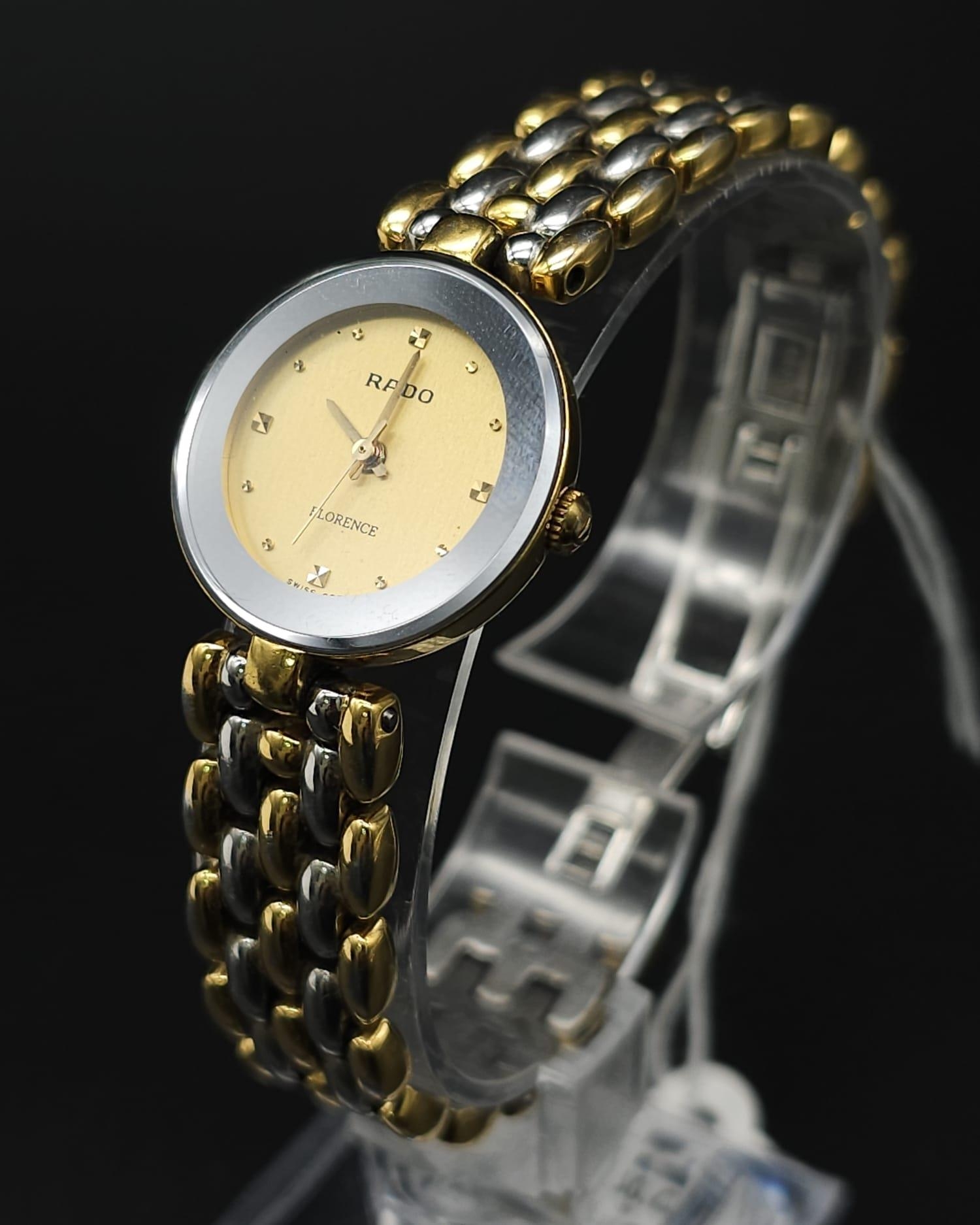 A Rado Florence Quartz Ladies Watch. Two tone bracelet and case 23mm. Gold tone dial. Comes with