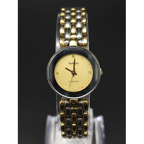 253 - A Rado 'Florence' Quartz Ladies Watch. Two tone bracelet and case - 23mm. Gold tone dial. Comes with... 