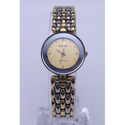 253 - A Rado 'Florence' Quartz Ladies Watch. Two tone bracelet and case - 23mm. Gold tone dial. Comes with... 