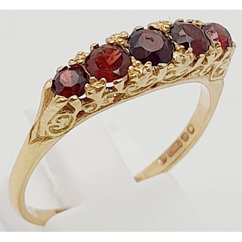 257 - 9K YELLOW GOLD 5 STONE GARNET RING. TOTAL WEIGHT  3.1G.  SIZE T