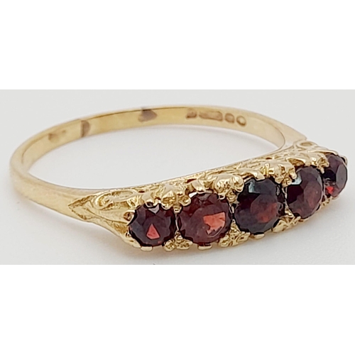 257 - 9K YELLOW GOLD 5 STONE GARNET RING. TOTAL WEIGHT  3.1G.  SIZE T
