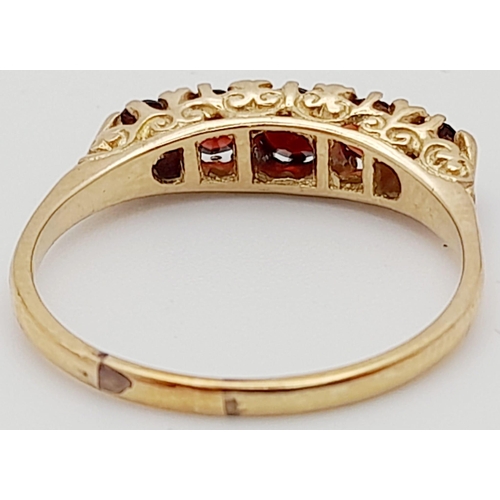 257 - 9K YELLOW GOLD 5 STONE GARNET RING. TOTAL WEIGHT  3.1G.  SIZE T