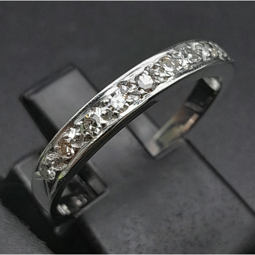 271 - 9K WHITE GOLD DIAMOND 1/2 ETERNITY RING.  0.22CT DIAMOND. TOTAL WEIGHT 1.8G.  SIZE O