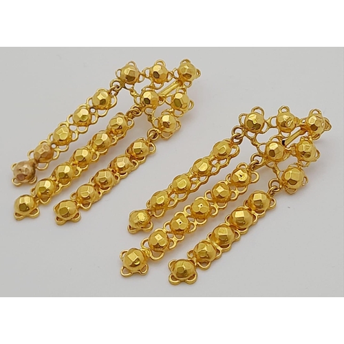 150 - A Pair of 18K Yellow Gold Drop Earrings. Ball on pierced decoration. 10.42g total weight. 4cm drop. ... 