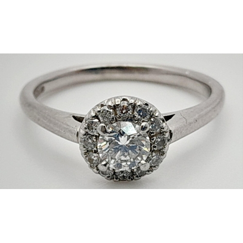 185 - A 950 Platinum Diamond Ring. Round brilliant cut central diamond with a diamond halo. 0.5ct approx. ... 