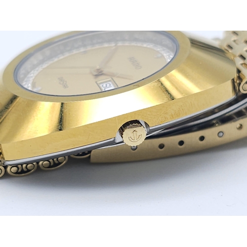 407 - A Gold Plated Rado Diastar Unisex Watch. Gold plated bracelet and case - 36mm. Gold tone dial with d... 