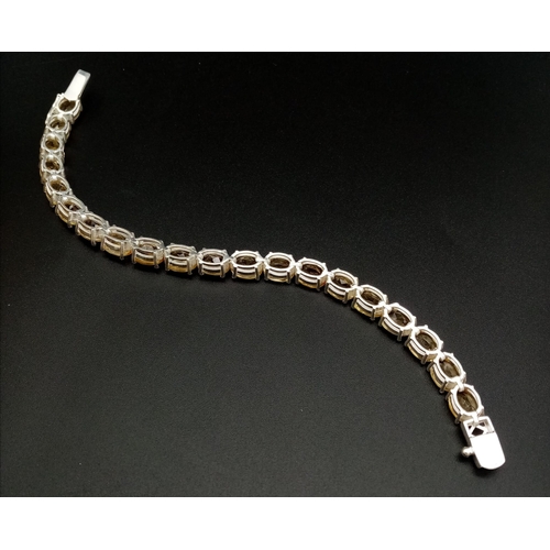 1749 - A Citrine Gemstone Tennis Bracelet set in 925 Silver. Beautiful, clean citrines. 20cm.  20.58g.