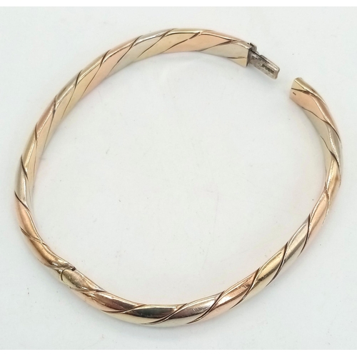 2 - A Vintage 9K Tri-Colour Gold Bangle. Yellow, rose and white gold diagonal strip decoration. Clip ope... 